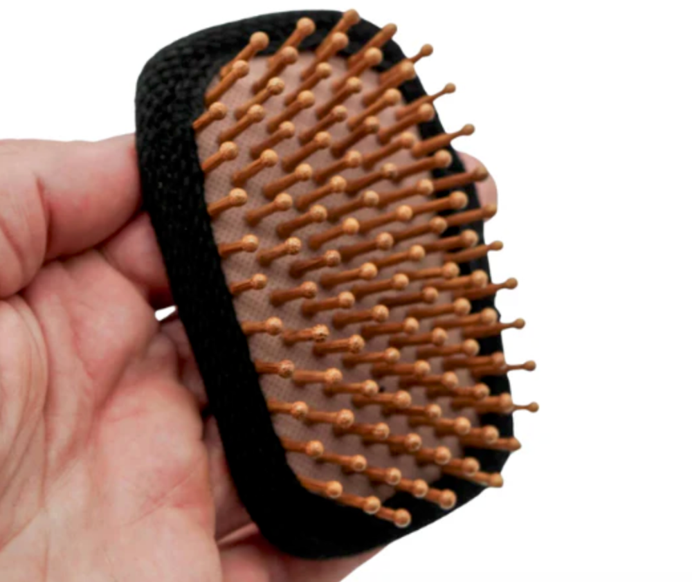 A small paddle brush for backpackers and hikers