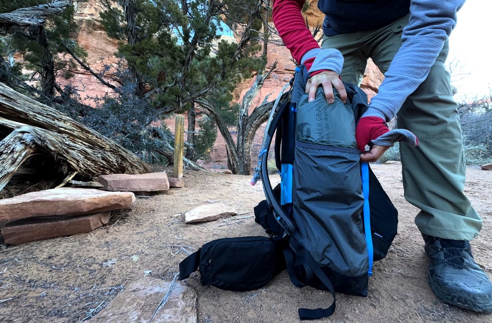 an ultralight backpacker setting up his lightweight gear at a campsite he hiked to