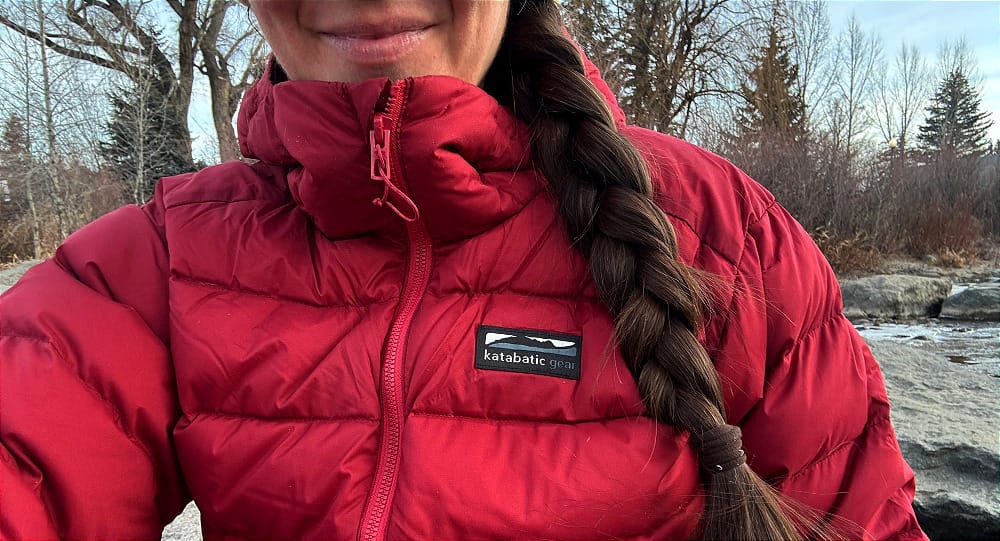 a close up of the katabatic gear tincup down jacket in a winter scene