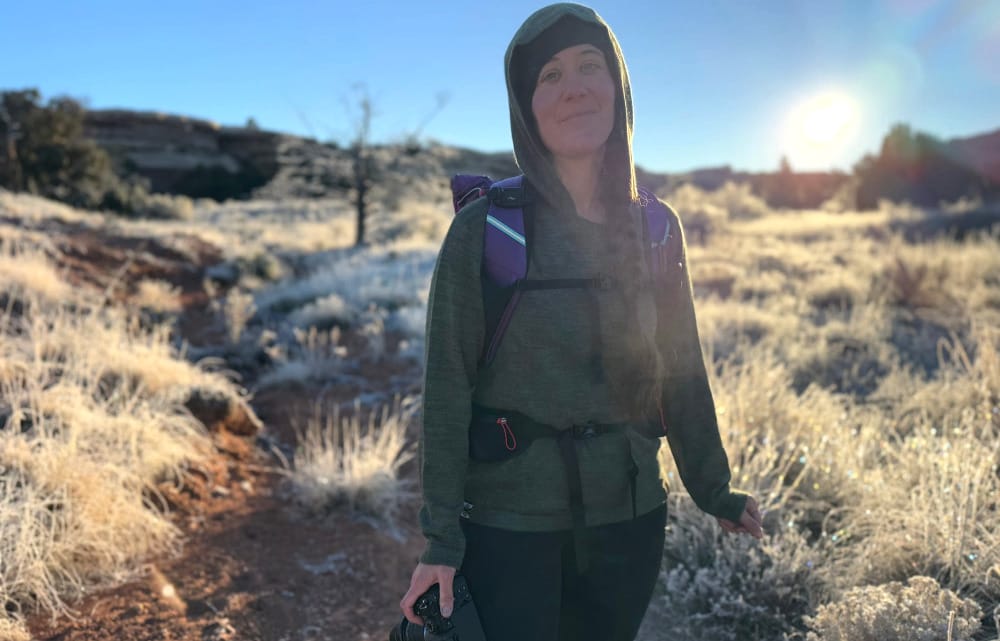 a hiker wearing paka alpaca wool clothing on an adventure