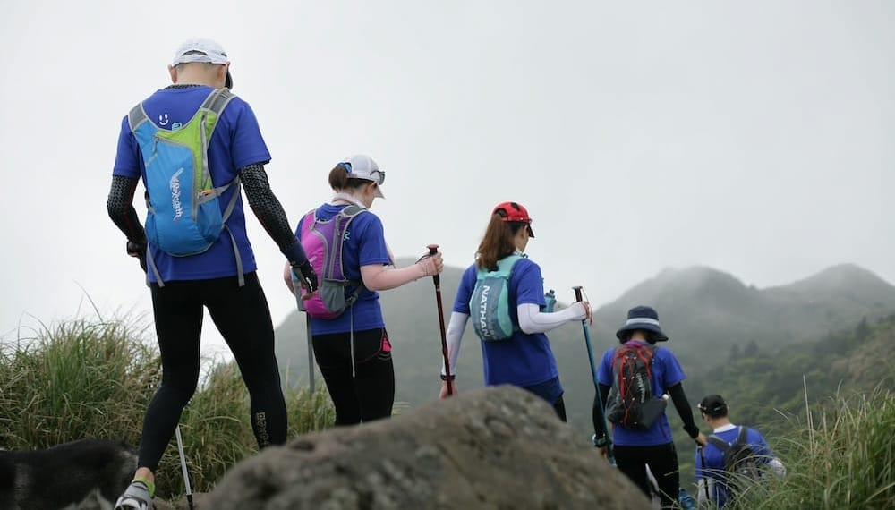 a group of people using trekking poles correctly