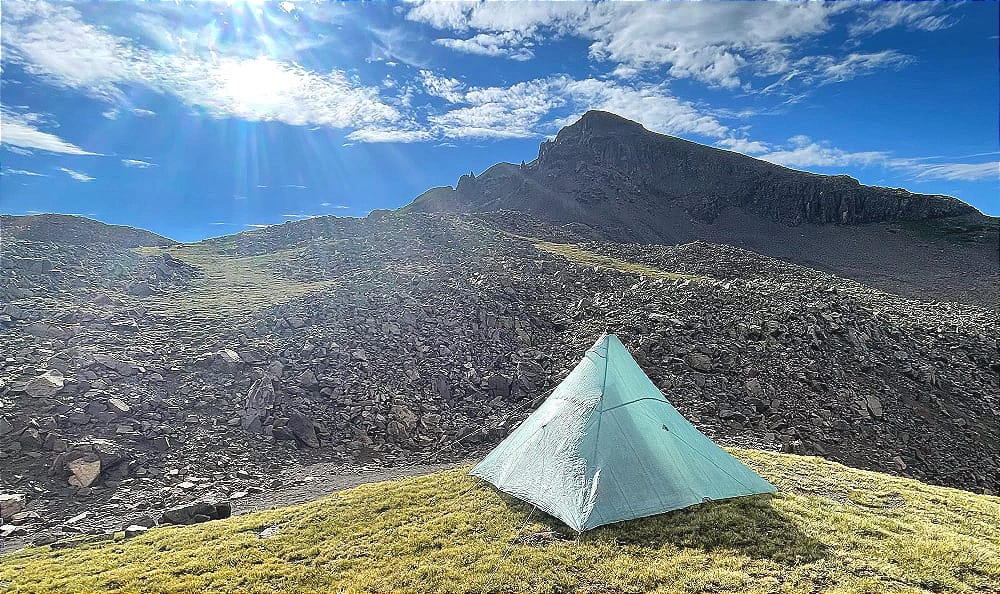 a hyperlite mountain gear ultralight tent pitched in a mountain setting which exemplifies what ultralight is all about