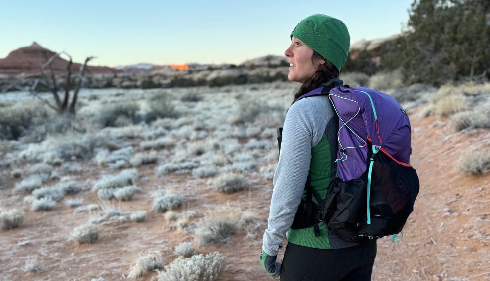 an ultralight backpacker in the southwest soaking up the glow of early morning in canyon country