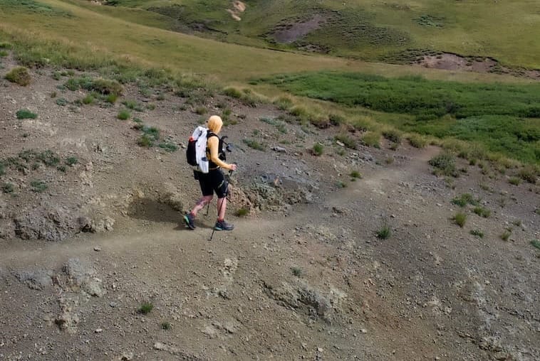 using trekking poles to hike in the mountains