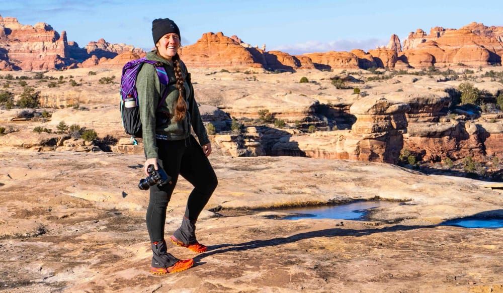 a hiker wearing a gossamer gear ultralight backpack in the southwest with a dramatic landscape