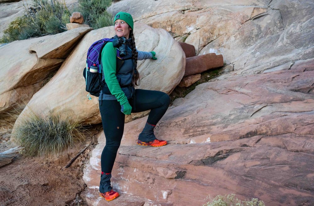 a hiker wearing one of the honorable mention best fleece hoodies of 2025 on a slick rock hike in the southwest