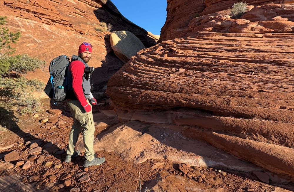 a man hiking in canyonlands wears one of the best fleece hoodies of 2025 the skygoat camp hoodie