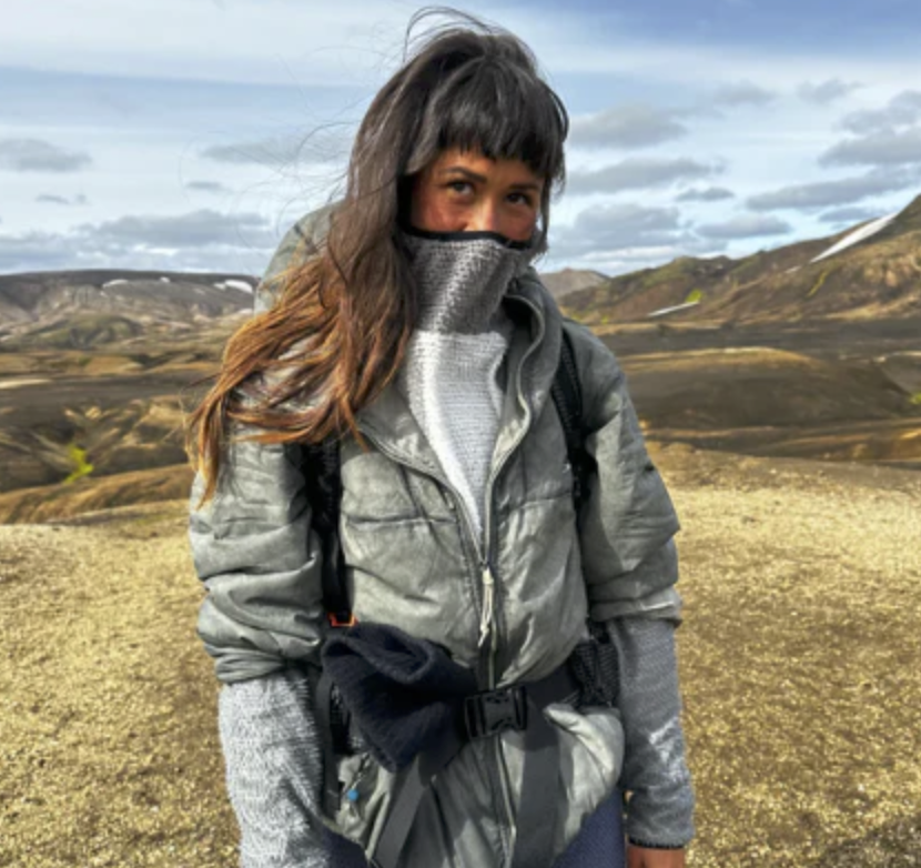 a hiker wears one of the best hiking fleece hoodies of 2025 in the alpine of the southwest rockies