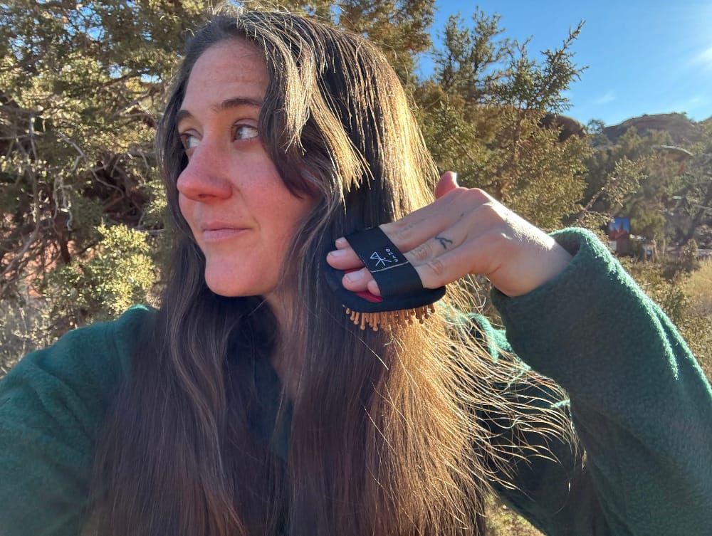 Hiker Hairbrush By Chicken Tramper Ultralight Gear in action on a backpacker's long hair