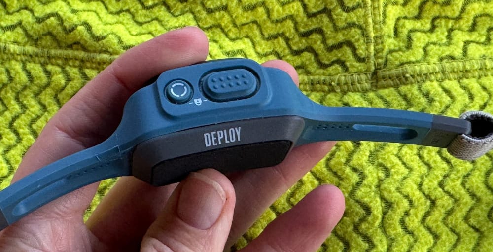 a close up of the deploy 325 headlamp's padding, on switch and lock mechanism button for backpacking