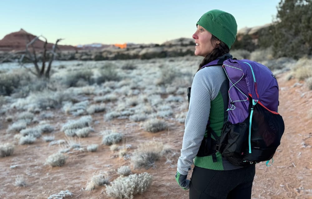 a hiker wearing a gossamer gear backpack on a cold weather hike where ultralight makes a big difference