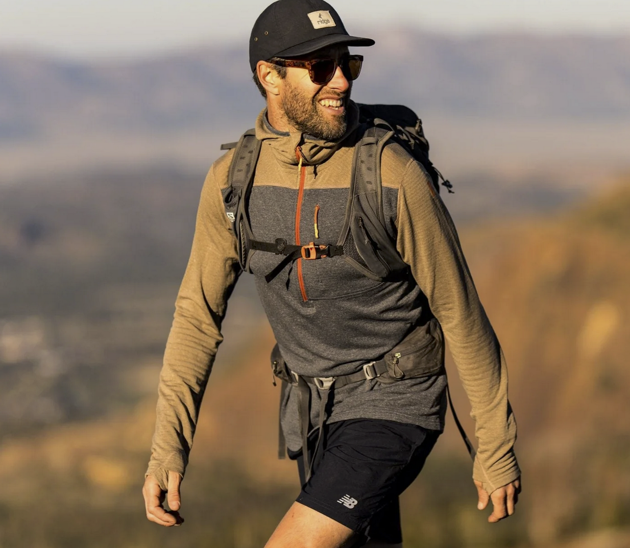 a man wears one of the best hiking fleece hoodies of 2025 on a big adventure above treeline