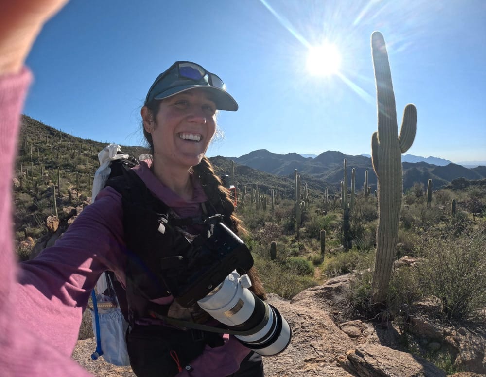 a hiker takes a selfie in the sonoran desert on a very hot summer day