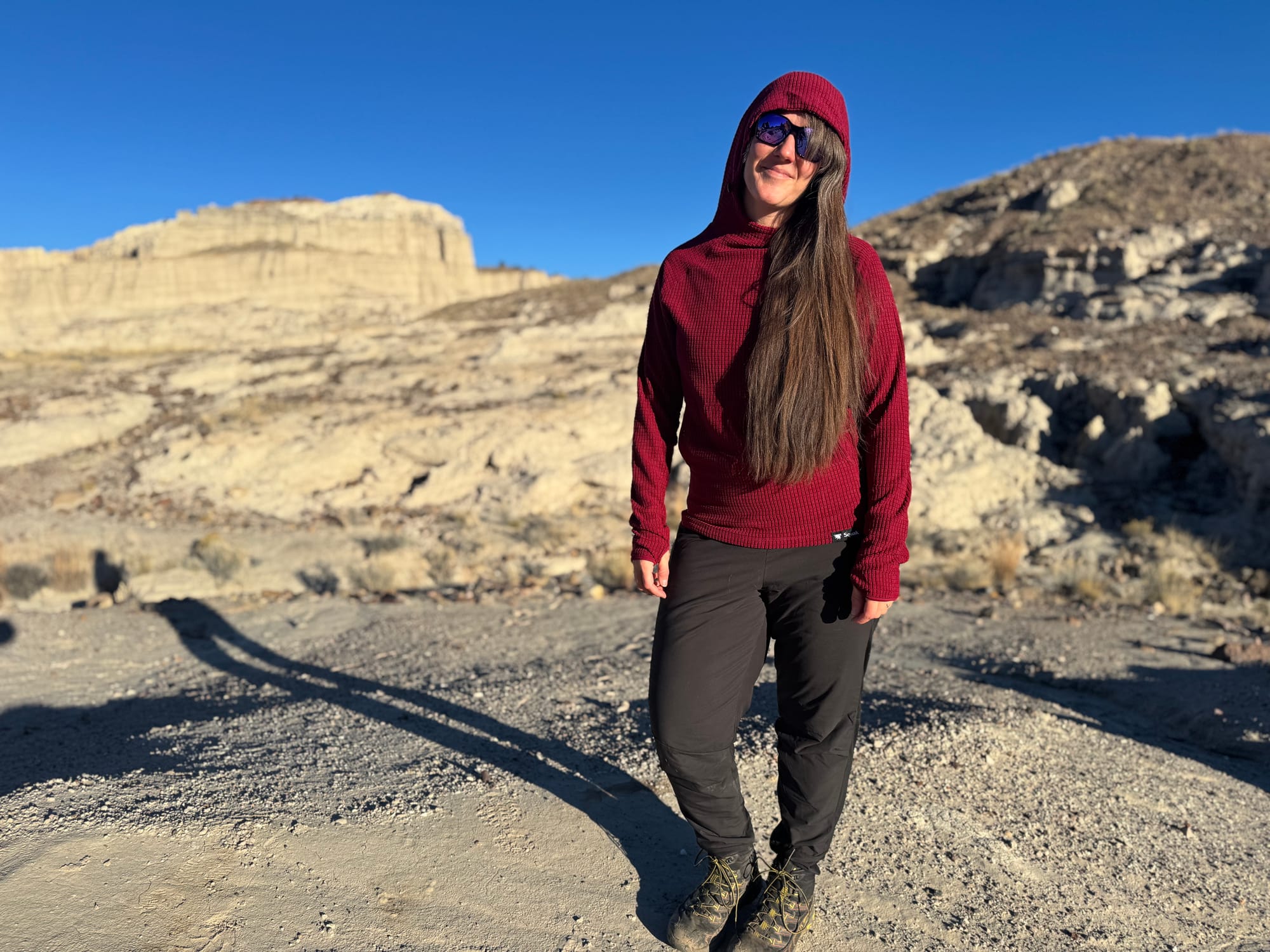 a woman wearing squak grid fleece hoodie in the high desert, it is one of the best hiking fleece hoodies of 2025