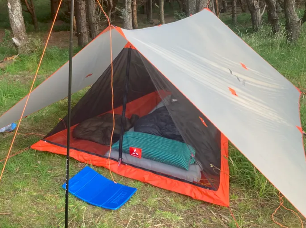 a simple image of a backpackers setup with one of the best solo backpacking ultralight tents