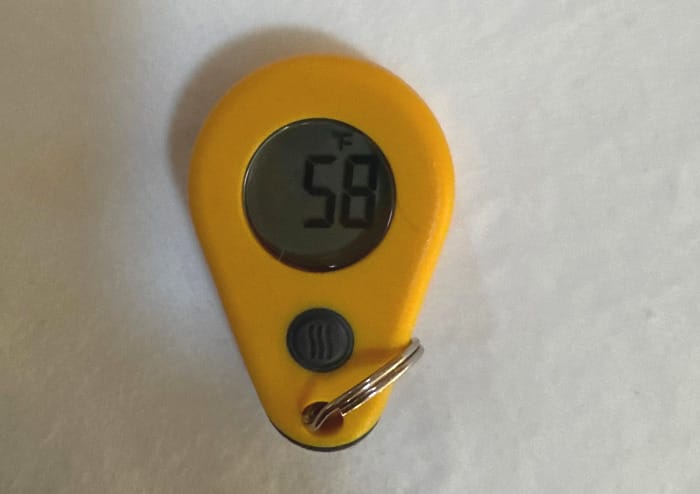 The Gear Review: Zipper-Pull Thermometer by ThermoWorks on a bed.