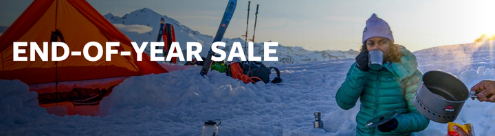 a banner about the therm-a-rest end of year sale 2024 featuring a woman sipping coffee in a camp