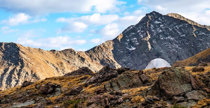 slingfin portal 3 tent pitched in the alpine with a dramatic mountain view on a backpacking trip in the rockies